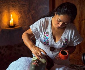 a woman applying a mask on a woman's face